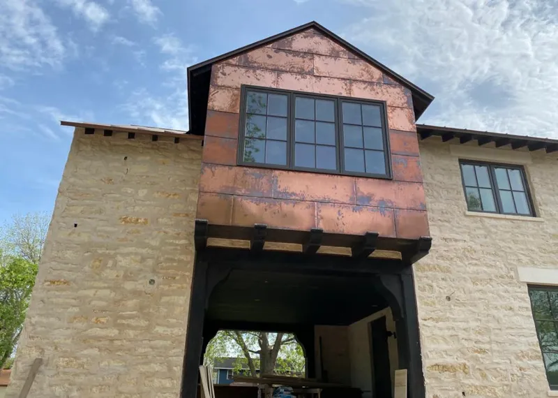 Copper metal panel facade on a stone building for Skylight Installation in Rindge