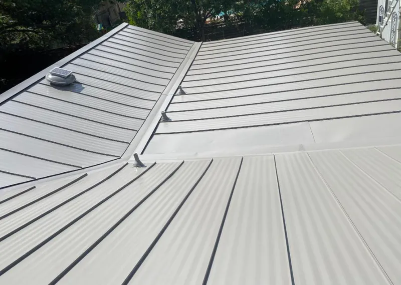 Solar attic fan installed on a metal roof for Roof Ventilation in Rindge